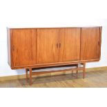 A 1960's Danish teak sideboard cabinet, the four sliding doors enclosing an arrangement of