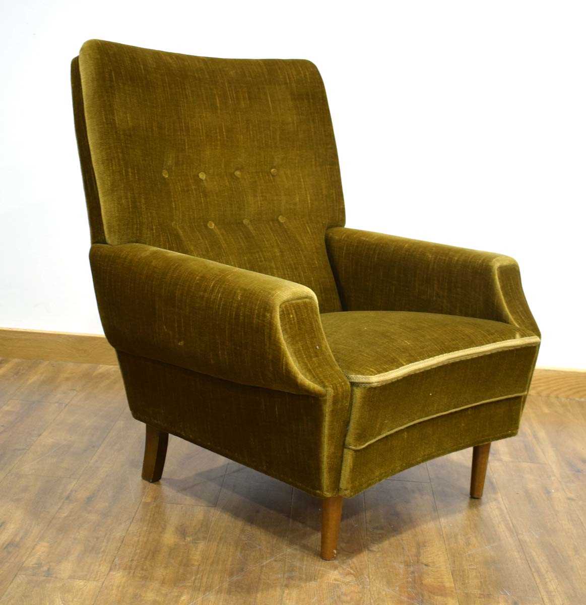 A 1950's highback armchair upholstered in dark green button upholstery *Sold subject to our Soft