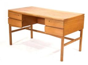 A 1960/70's Danish oak and crossbanded desk with four drawers on square straight supports, in the
