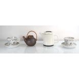 An Arabia Faenza coffee pot, a pair of large Emilia cups and saucers and a small brown Arabia teapot