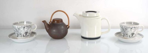 An Arabia Faenza coffee pot, a pair of large Emilia cups and saucers and a small brown Arabia teapot