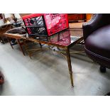 A 1980's brass finished coffee table with a rectangular smoked glass surface and reeded legs in