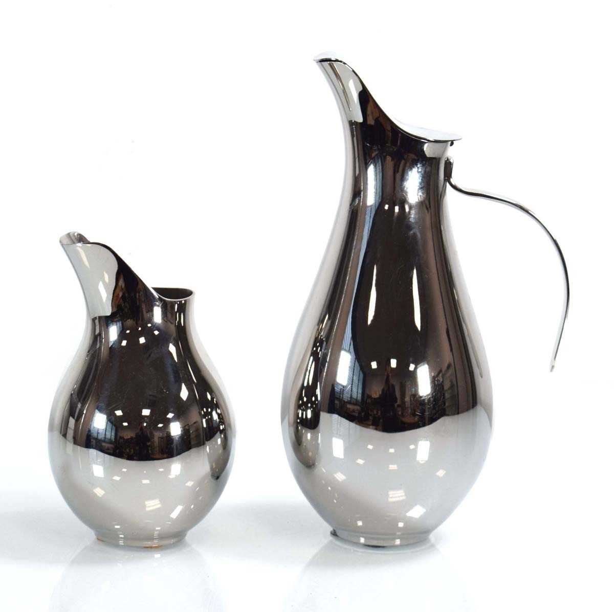 A Georg Jensen lidded jug or pitcher, h. 26 cm, together with a smaller matching milk jug (2)