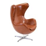 After Arne Jacobsen, an 'Egg' chair upholstered in brown leather on a four-star chromed base *Sold