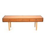 A 1960's teak three-drawer low side table on later beech tapering legs, 153 x 45 x 53 cm