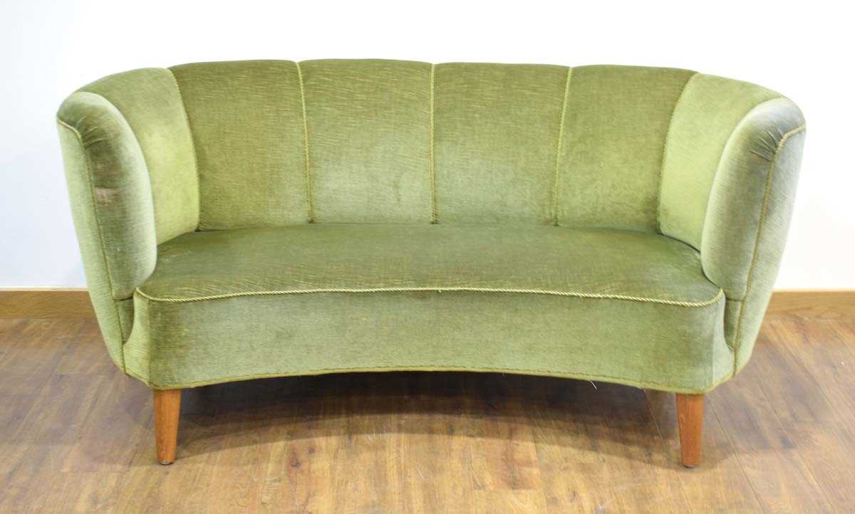 A 1950's Danish 'Banana' sofa upholstered in green on teak triangular feet *Sold subject to our Soft