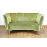 A 1950's Danish 'Banana' sofa upholstered in green on teak triangular feet *Sold subject to our Soft