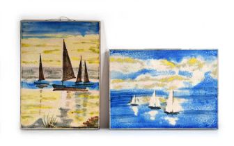 A pair of German ceramic wall plaques by Karlsruhe Majolika Company, each depicting boats at sea, 46