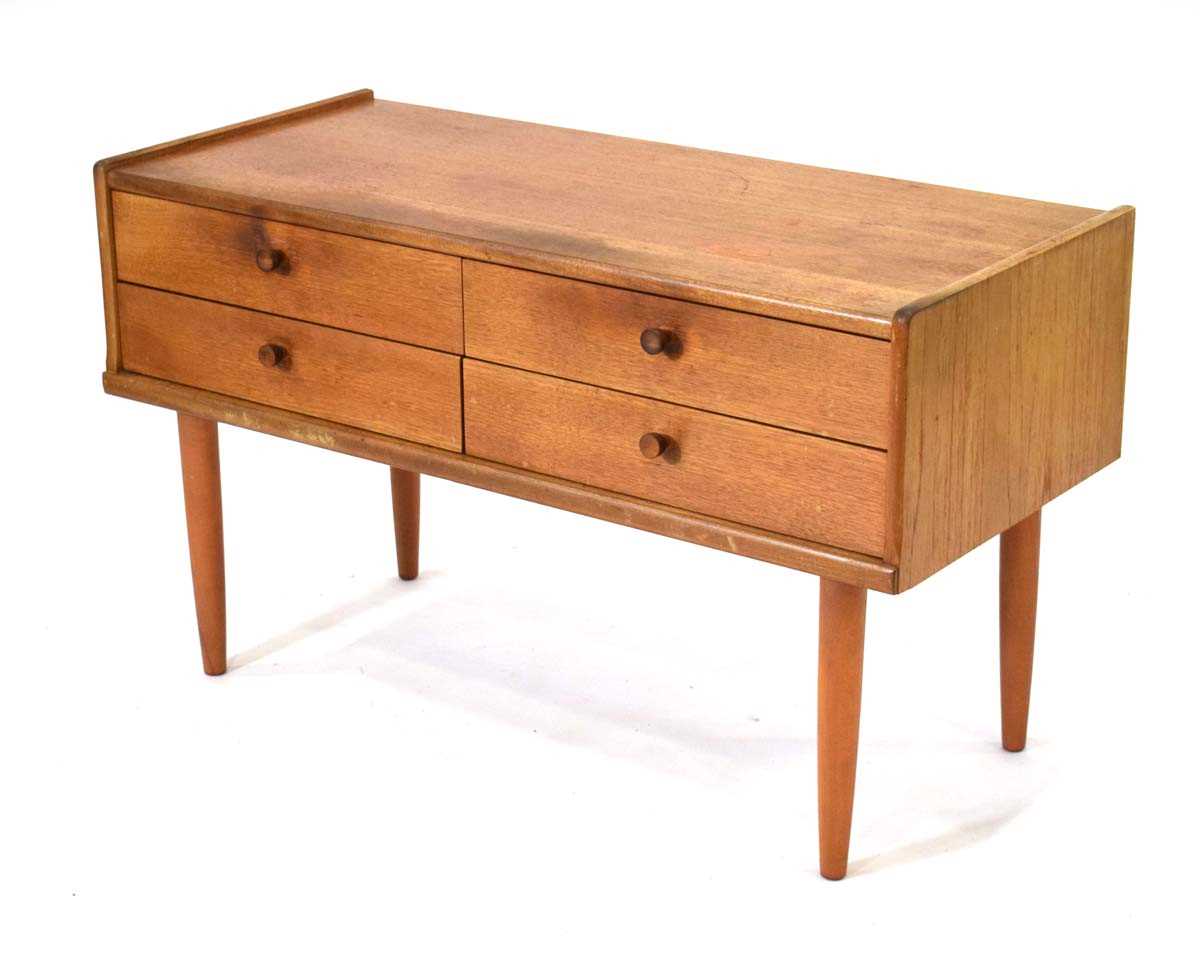 A 1970's teak four-drawer chest on later slender legs, 102 x 45 x 60 cm