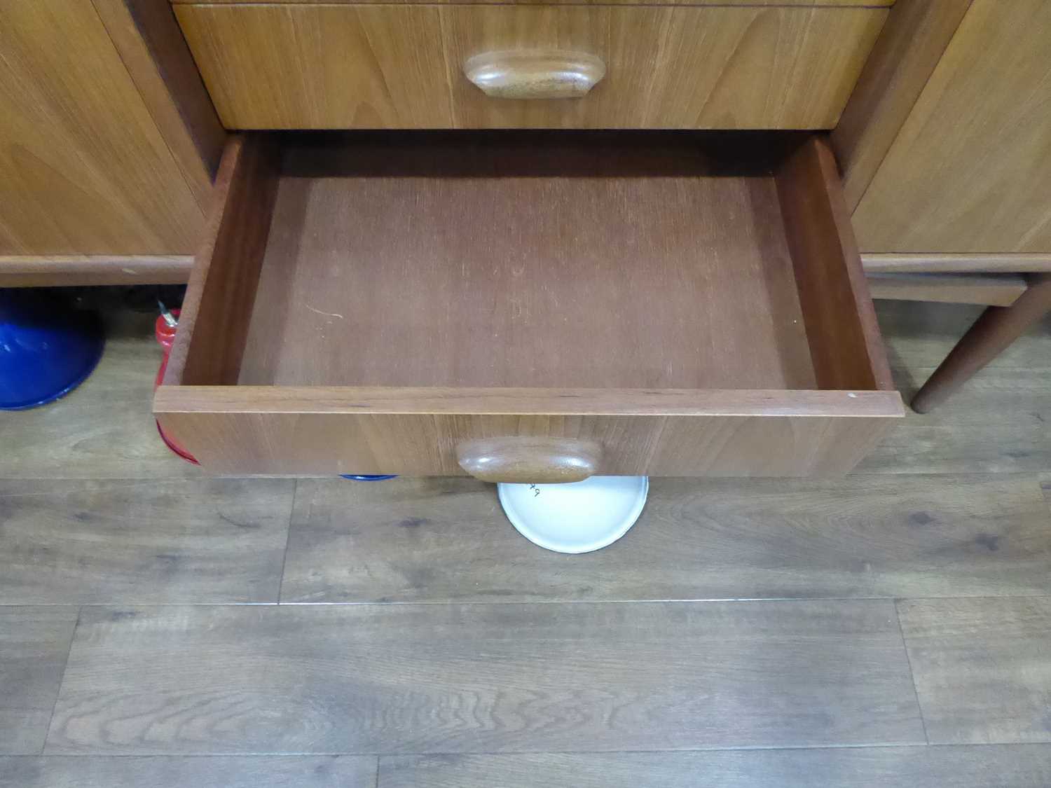 A 1960's G-Plan teak sideboard with a pair of doors, four drawers and a fall-front door, on tapering - Image 23 of 25