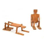 A pair of 1980's pine articulated side tables or mannequins in the form of stylised figures One