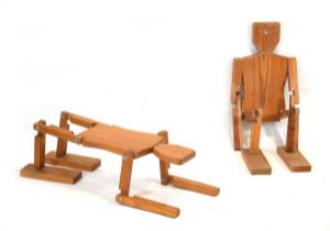 A pair of 1980's pine articulated side tables or mannequins in the form of stylised figures One