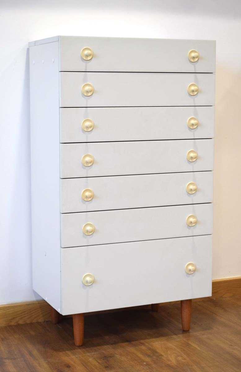 A 1960's German white laminate chest of drawers with a lift-surface by Interlubke, w. 64 cm, h.