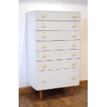 A 1960's German white laminate chest of drawers with a lift-surface by Interlubke, w. 64 cm, h.