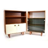 A 1970's teak cabinet with two smoked glass doors, together with a similar bookcase with two white