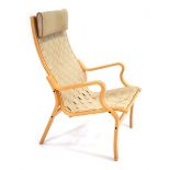 A 1960's Danish beech bentwood armchair with a webbed seat, designed by Finn Ostergaard