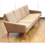 A 1960's oak framed three-seater sofa upholstered in green and white check fabric, w. 228 cm *Sold