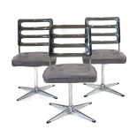 A set of three 1970's Chromcraft dining chairs with smoked perspex backs over grey seats on four-