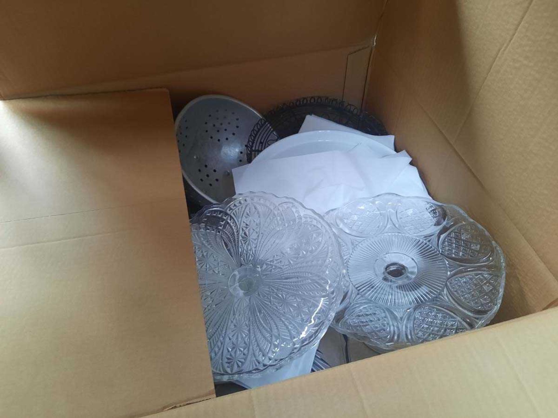 Box containing assorted glass and crockery cake stands