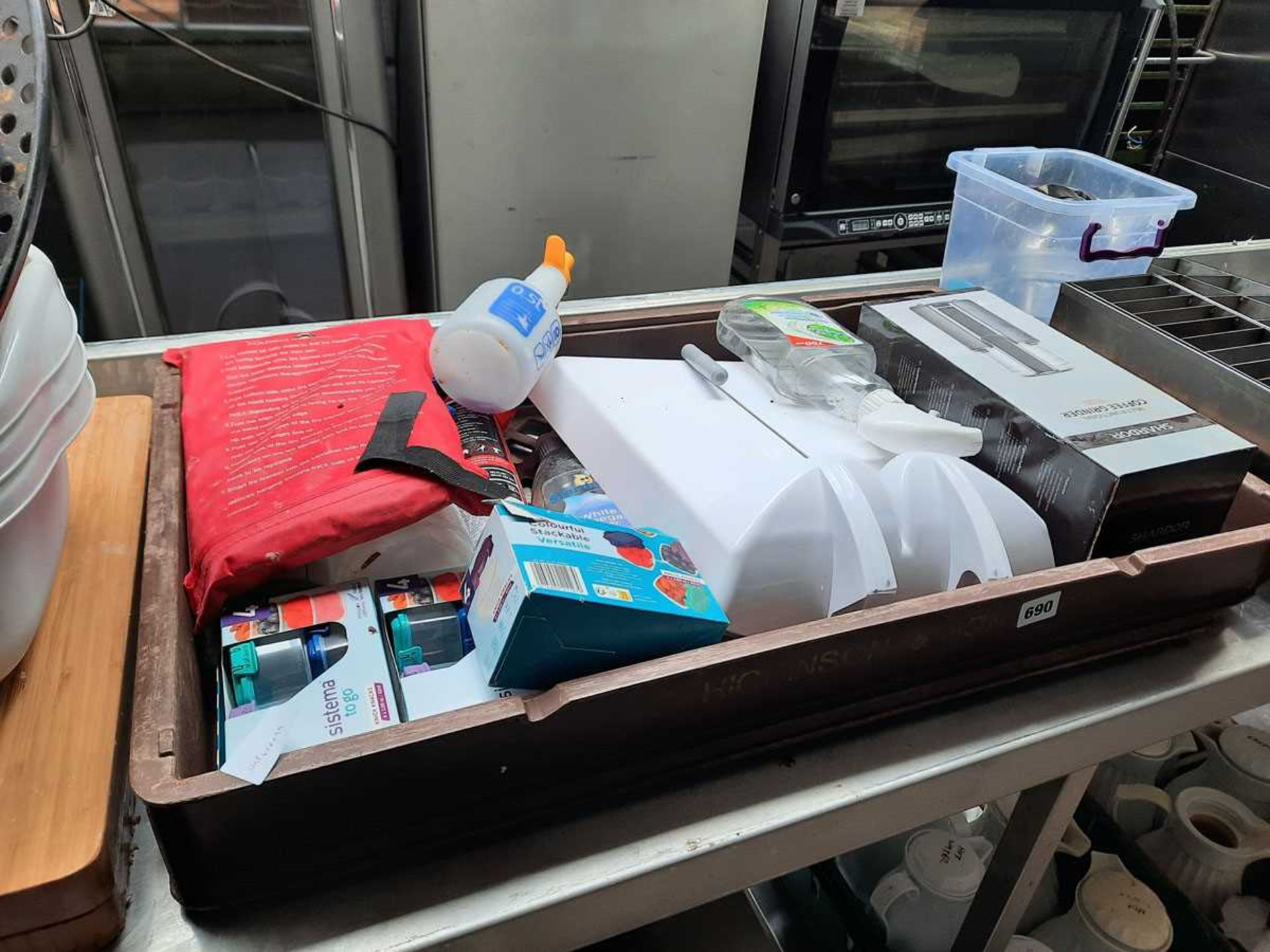 Bakers tray containing assorted items such as coffee grinder, cheese slice, fire curtain, washing up