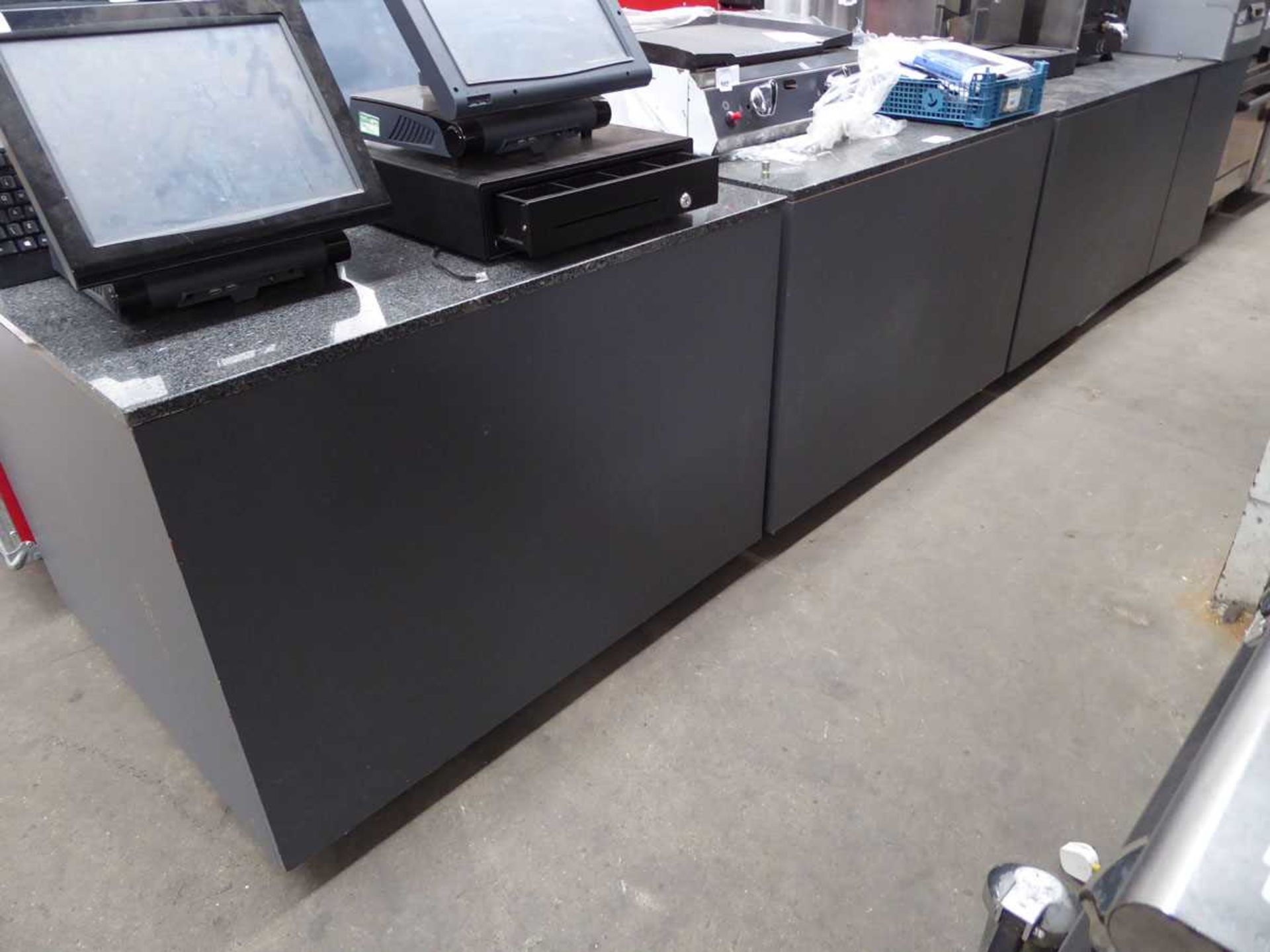 Shop counter with stone slab work surfaces in 5 modular sections, total length of approx 3.5m