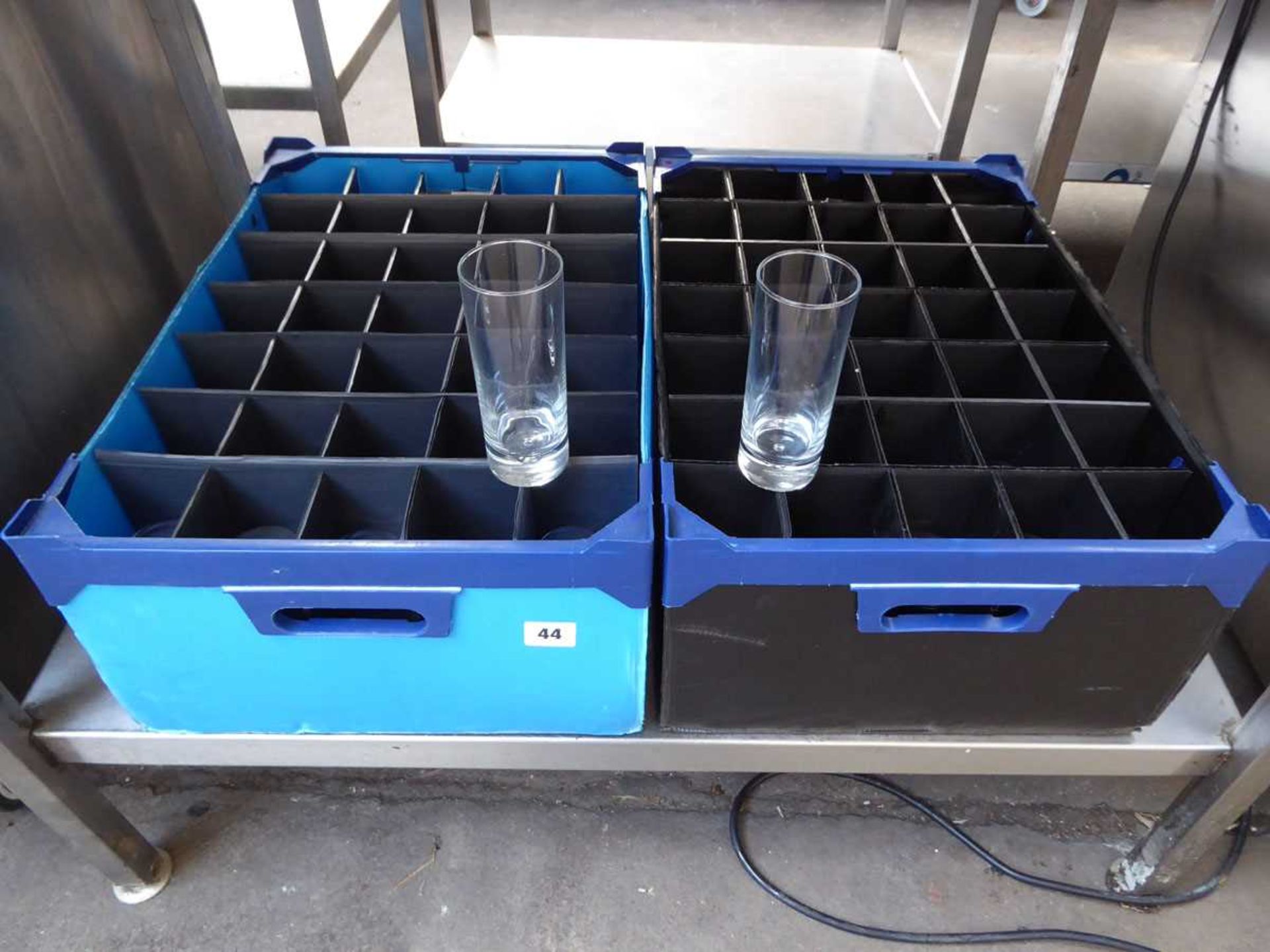 2 plastic crates containing a large qty of glass high ball glasses