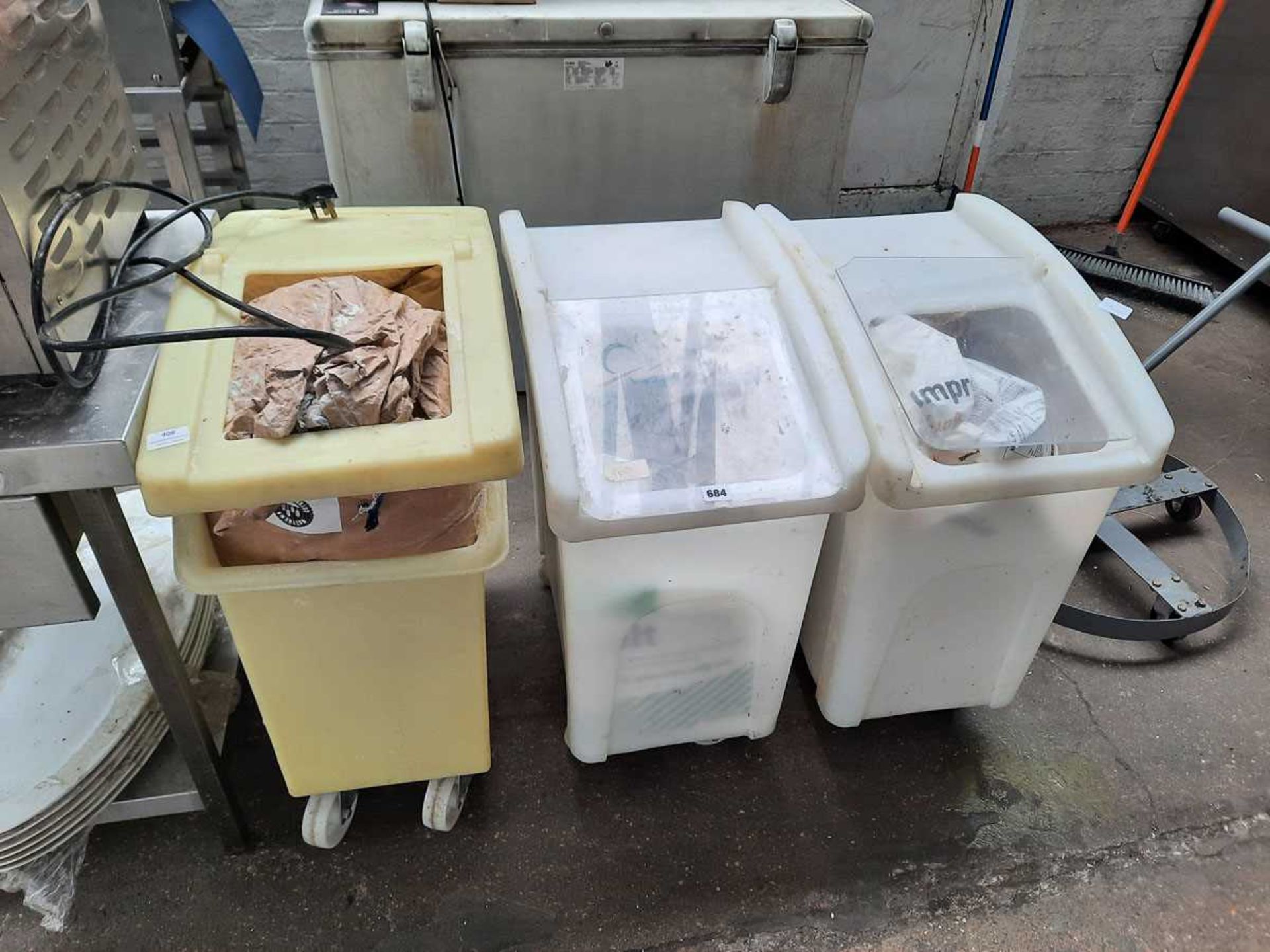 3 ingredients bins with contents, mostly flour