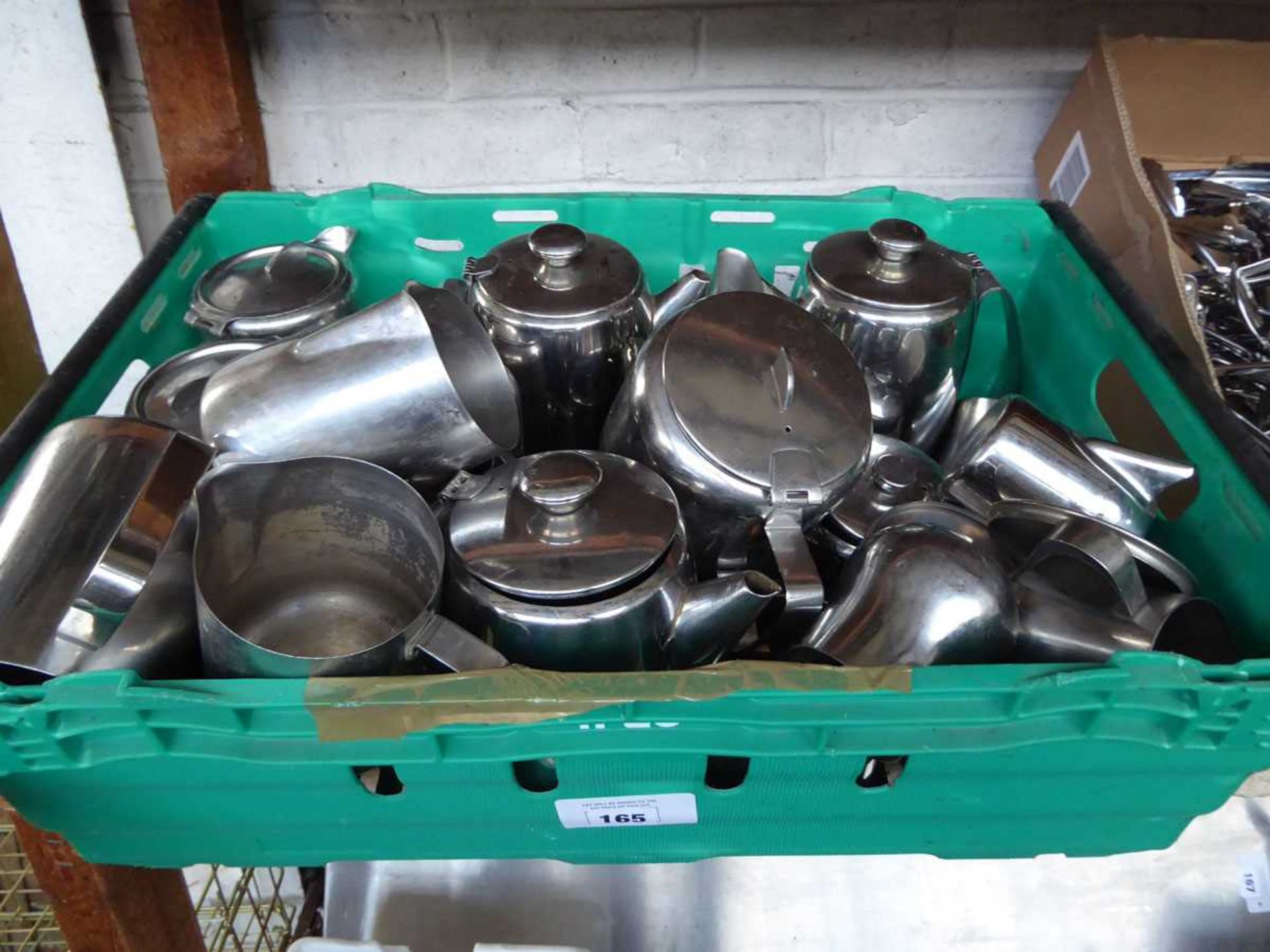 Tray containing assorted stainless steel teapots