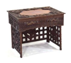 A late 19th century Chinese travelling campaign or scribes desk, the intricately carved surface with