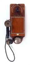 A 1910's Gent & Co. 'Secret Service' government telephone on a mahogany wall-mounted box
