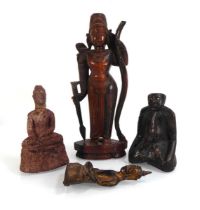 An Asian carved wooden sculpture modelled as a kneeling figure, h. 11 cm, together with a