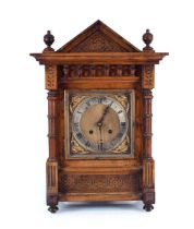 An early 20th century bracket clock, the face with silvered dial and Roman numerals, within a walnut