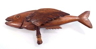 A Pitcairn Island articulated model of a fish, on a turned handle, inscribed 'Made by Fred Christian