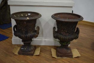 A pair of cast iron garden planters modelled as urns, each relief decorated with swags and