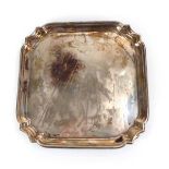 A mid-20th century silver salver of square form on four scrolled feet, William Hutton & Sons,