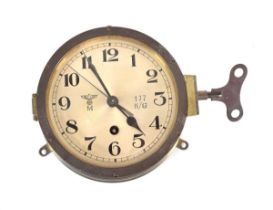 A Kriegsmarine Baltic Fleet bulkhead clock, the brass case with a silvered dial, Arabic numerals,