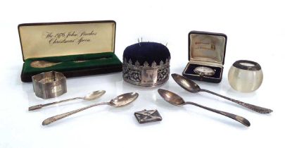 A mixed group of silver comprising a John Pinches Christmas spoon, four further spoons, a napkin