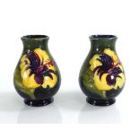 A pair of miniature Moorcroft vases, each decorated with hibiscus on a green ground, h. 9.5 cm (2)
