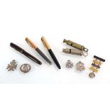 A small group of collectables including a Parker pen with a 14ct gold nib, four silver badges, a