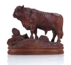 A late 19th/early 20th century 'Black Forest' carving modelled as a bull on a naturalistic plinth,