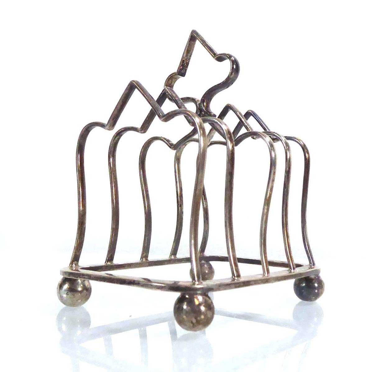 An Edwardian silver four-slice toast rack, maker RMEH, Sheffield 1909, w. 9.5 cm, 3.5 ozs Mis-