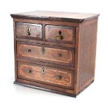 An apprentice chest of two short over three long graduated drawers, the mahogany body with satinwood