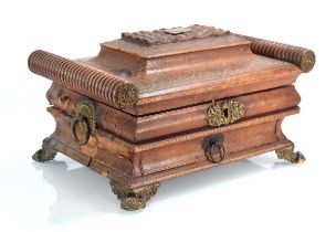 An early 19th century sewing box of casket form with turned cylindrical ends, a bombe body, fitted