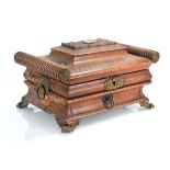 An early 19th century sewing box of casket form with turned cylindrical ends, a bombe body, fitted