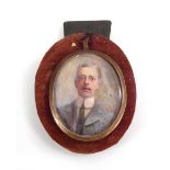 An early 20th century head and shoulders portrait miniature on ivory depicting Claude M Davies,