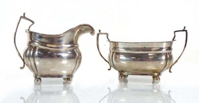 An early 20th century silver two handled sugar bowl with gadrooned decoration, together with a