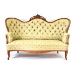 A Victorian walnut and button upholstered drawing room sofa on scrolled front legs, w. 168 cm