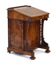A Victorian walnut davenport, the tooled leather sloping surface enclosing a maple fitted