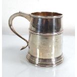 An early 20th century silver tankard of tapered form, Goldsmiths & Silversmiths Co. Ltd., 1928, h.