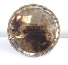 A mid-20th century silver salver of circular form on three claw and ball feet, Mappin & Webb,
